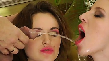 Two lesbians piss continuously while fucking with a cock