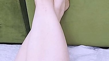 Anna lifted her foot up and is resting. Beautiful soft feet.